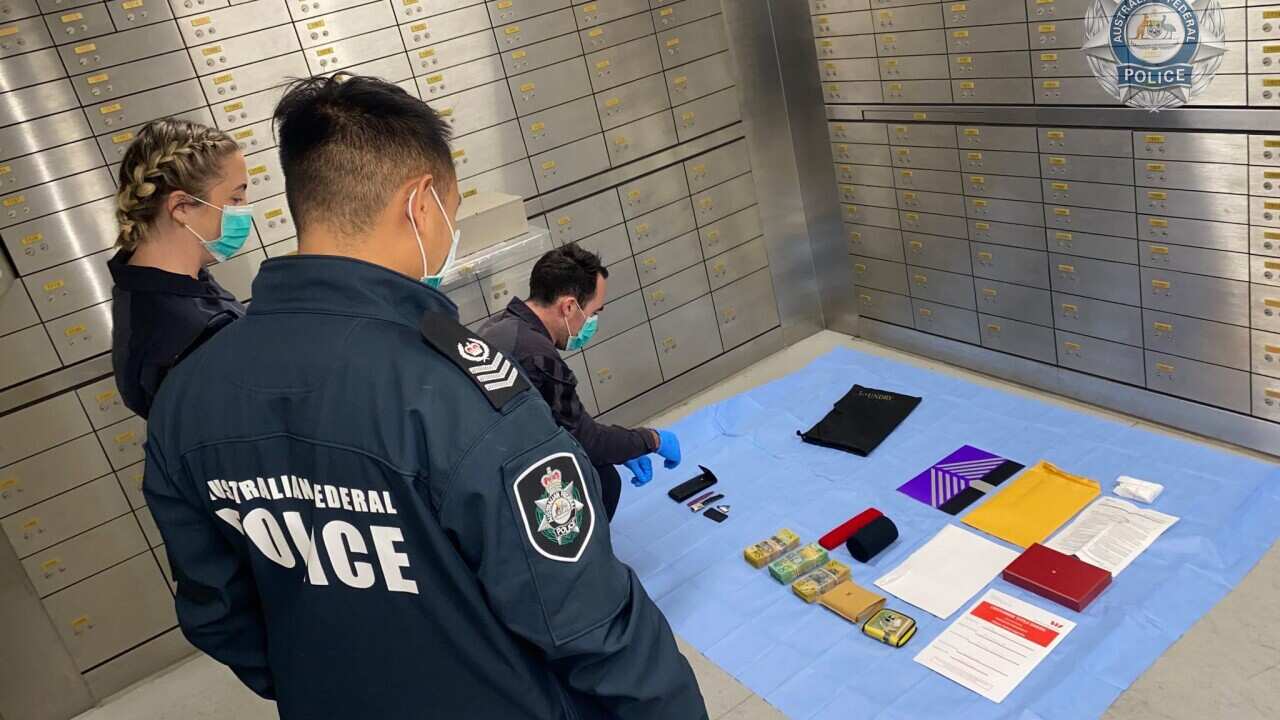 Australian Federal Police with their seized items as part of investigation (Supplied).jpg