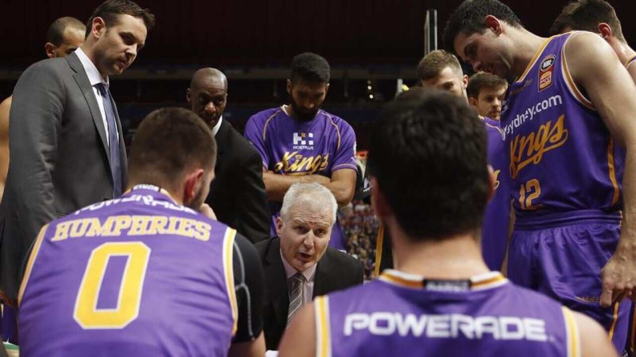 Andrew Gaze (centre) talks to his team during the NBL round two match.