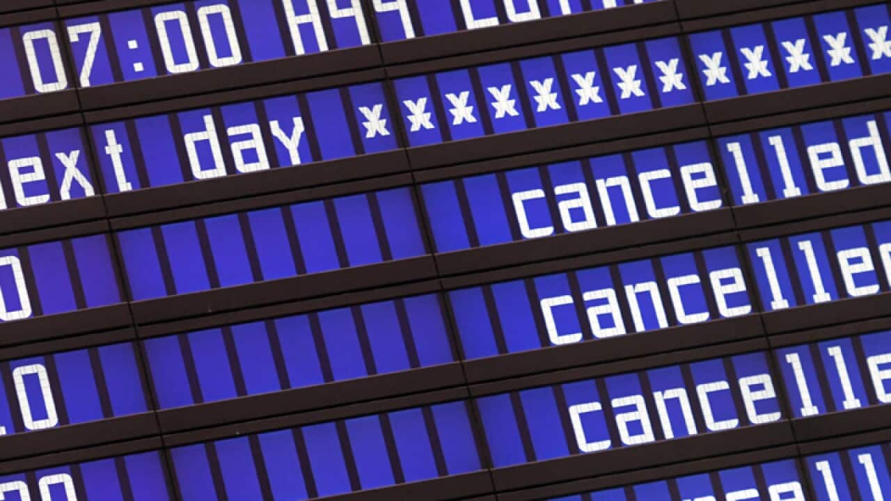 A display panel shows cancelled flights in Munich