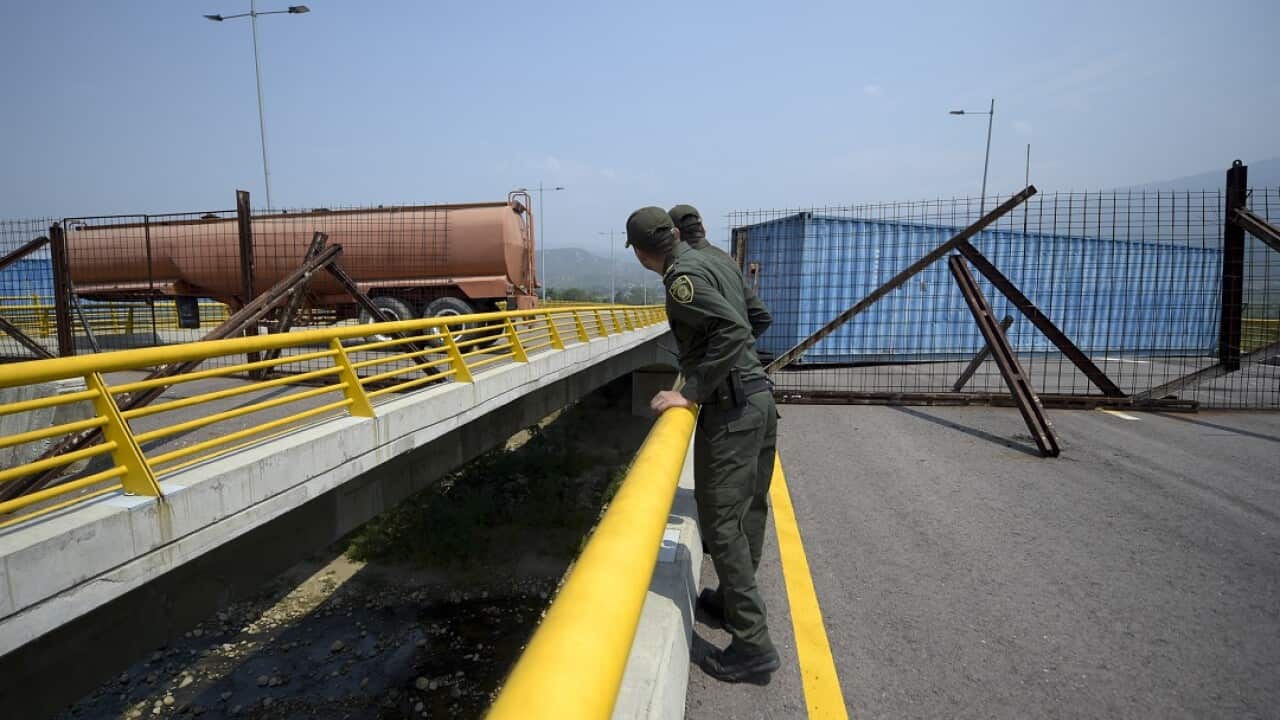 Containers block a key border bridge between Venezuela and Colombia. 