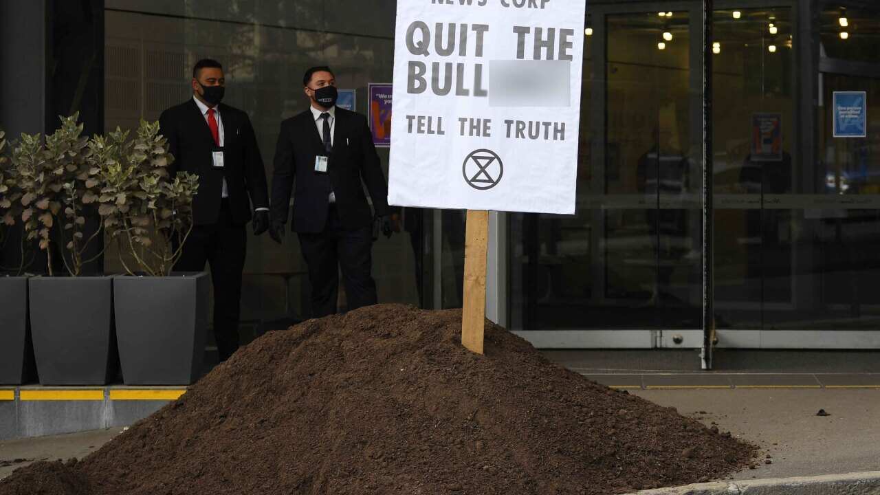 A pile of manure is dumped outside the News Corp Australia offices in Sydney, Friday, September, 4, 2020.
