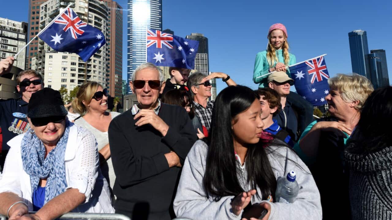 Crowds waving Australian flags watch veterans march to the Shrine of Remembrance for the Anzac Day march in Melbourne, Monday, April 25, 2016. (AAP Image/Tracey Nearmy) NO ARCHIVING