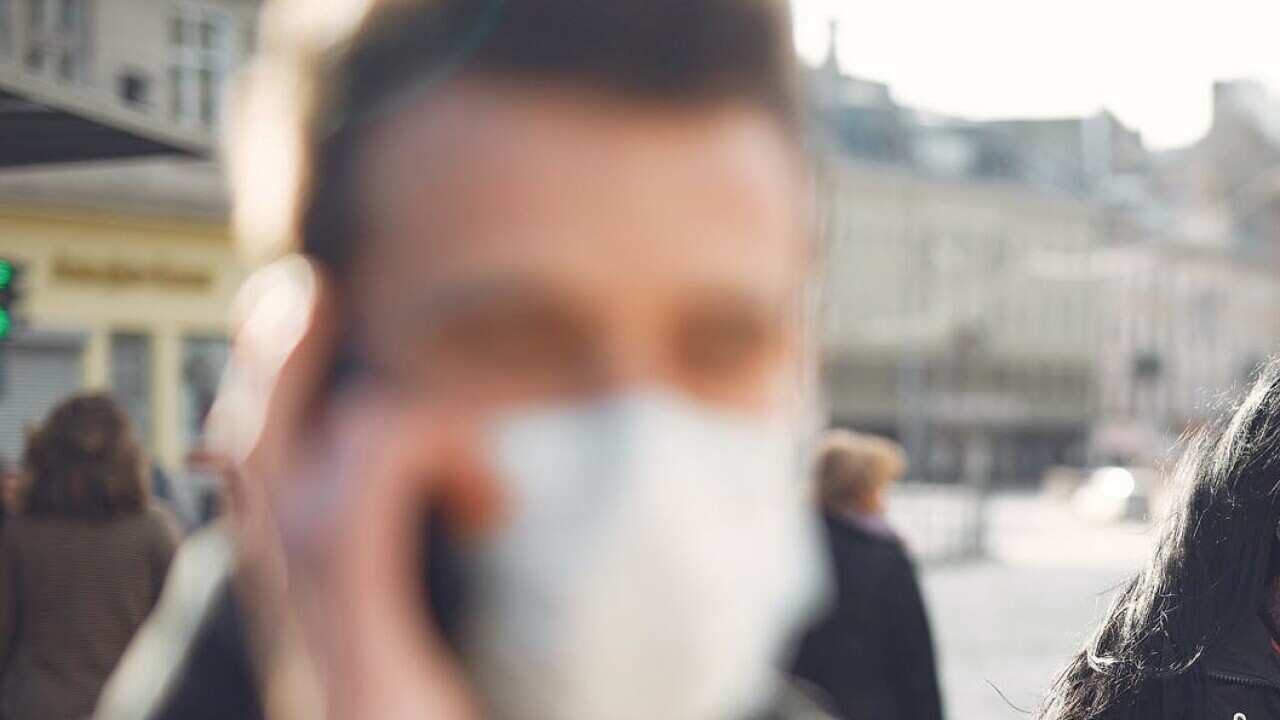 Mask wearing man and woman