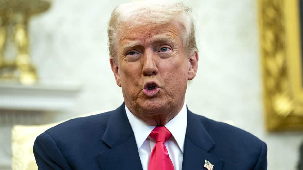 US President Donald Trump, wearing a suit and tie, is speaking.