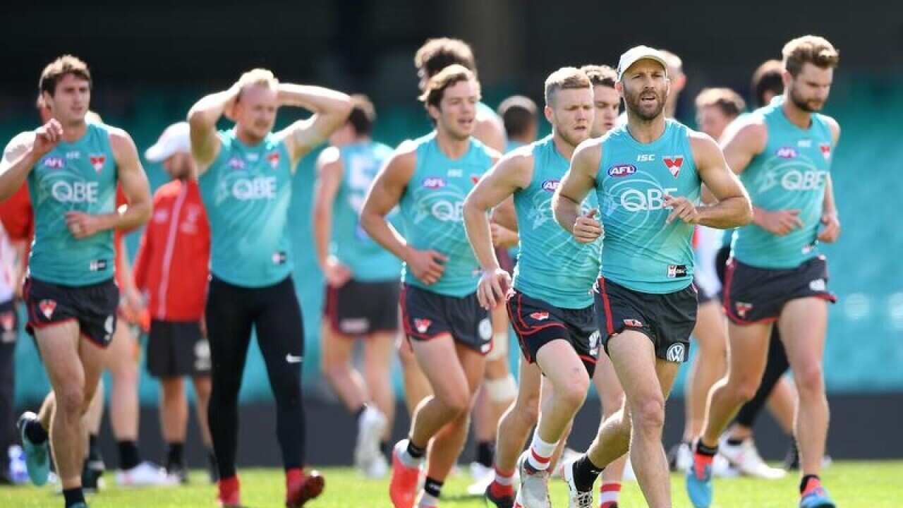 Jarrad McVeigh (right) runs during a team training session.