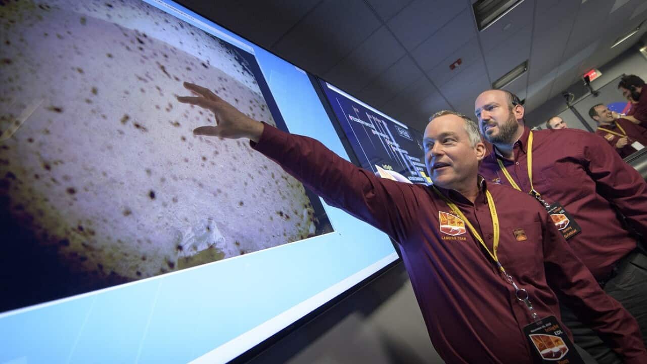 NASA's Tom Hoffman, InSight Project Manager, with the first image of Mars surface shortly after confirmation of a successful touch down.