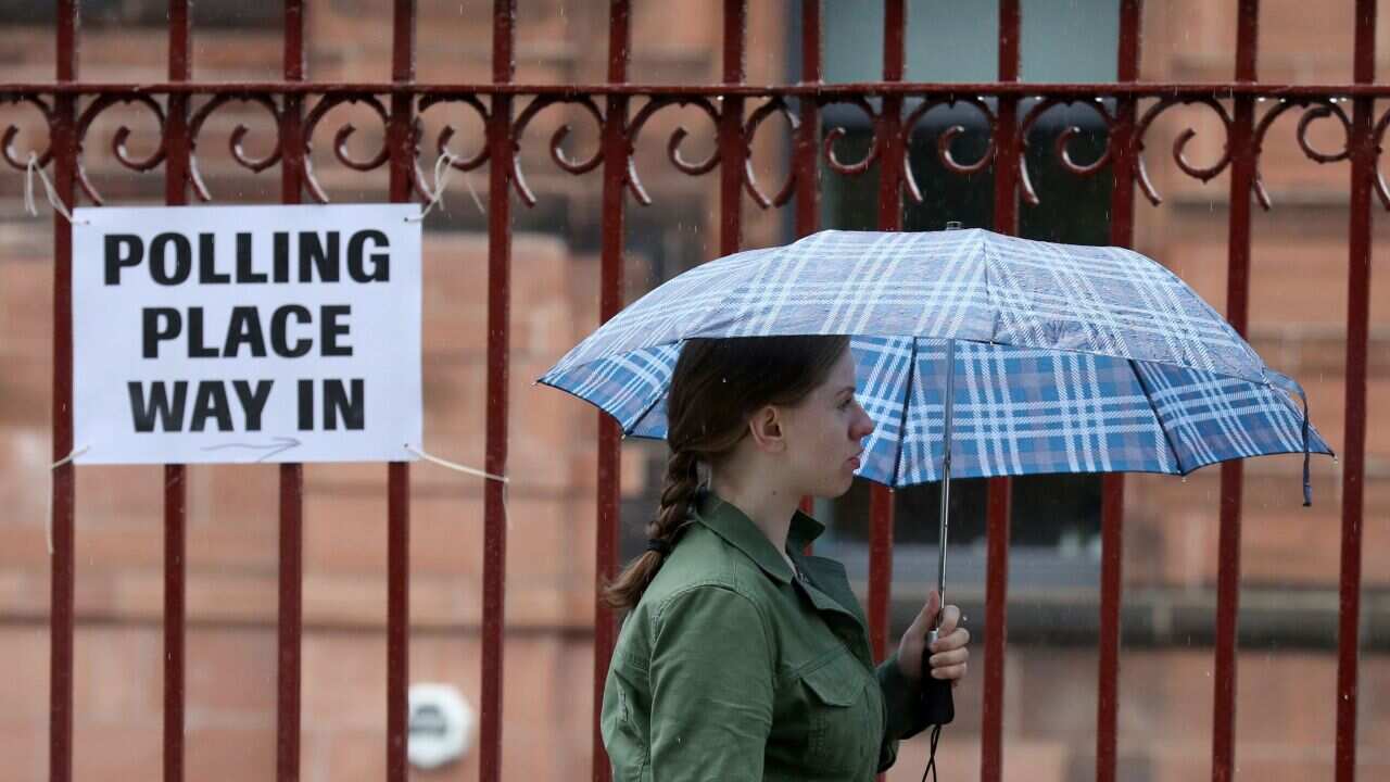 Voters arrive to cast their votes at a polling station at Notre Dame Primary School in Glasgow in the 2017 General Election.