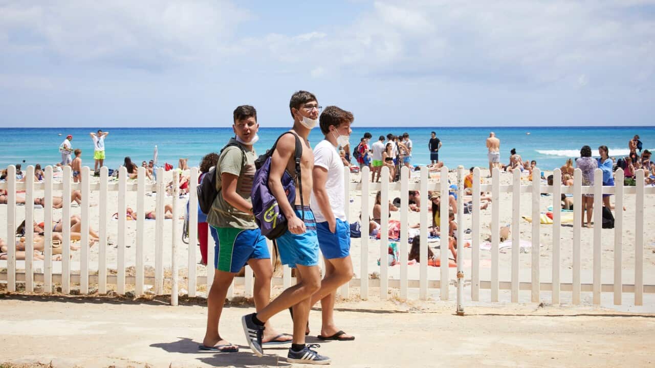 Some boys walk on Mondello beach on the first day of reopening of the bathing facilities after the lockdown on June 07, 2020 in Palermo Italy