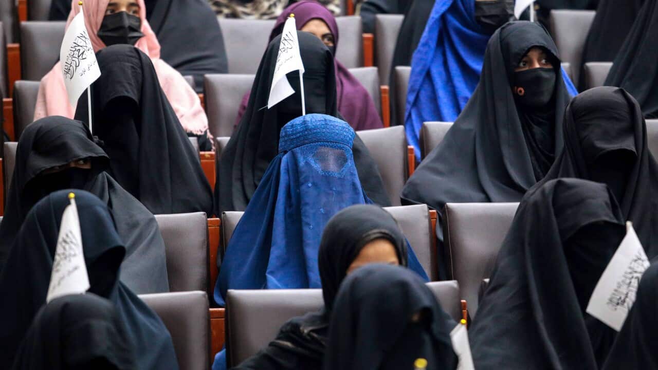 Afghan students listen to female speakers prior to their pro-Taliban rally outside the Shaheed Rabbani Education University in Kabul, Afghanistan