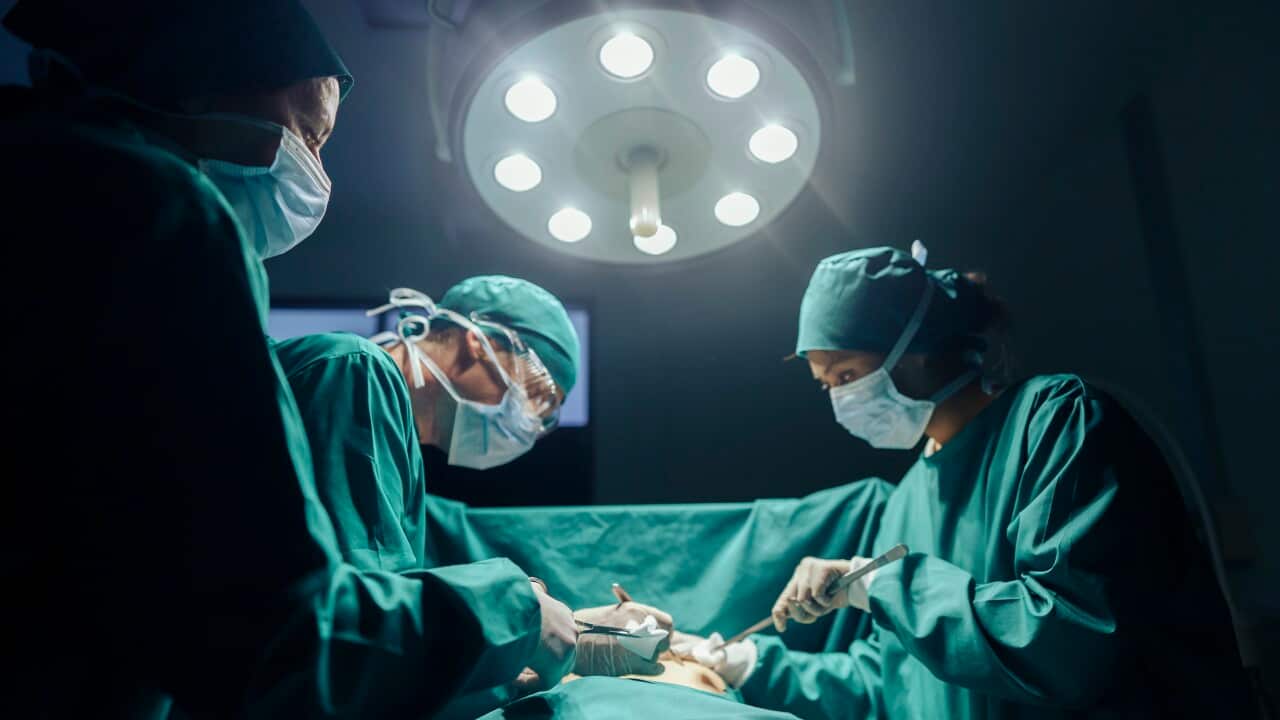 Teamwork and Cooperation Three Surgeons performing operating on a patient in the hospital's operating room