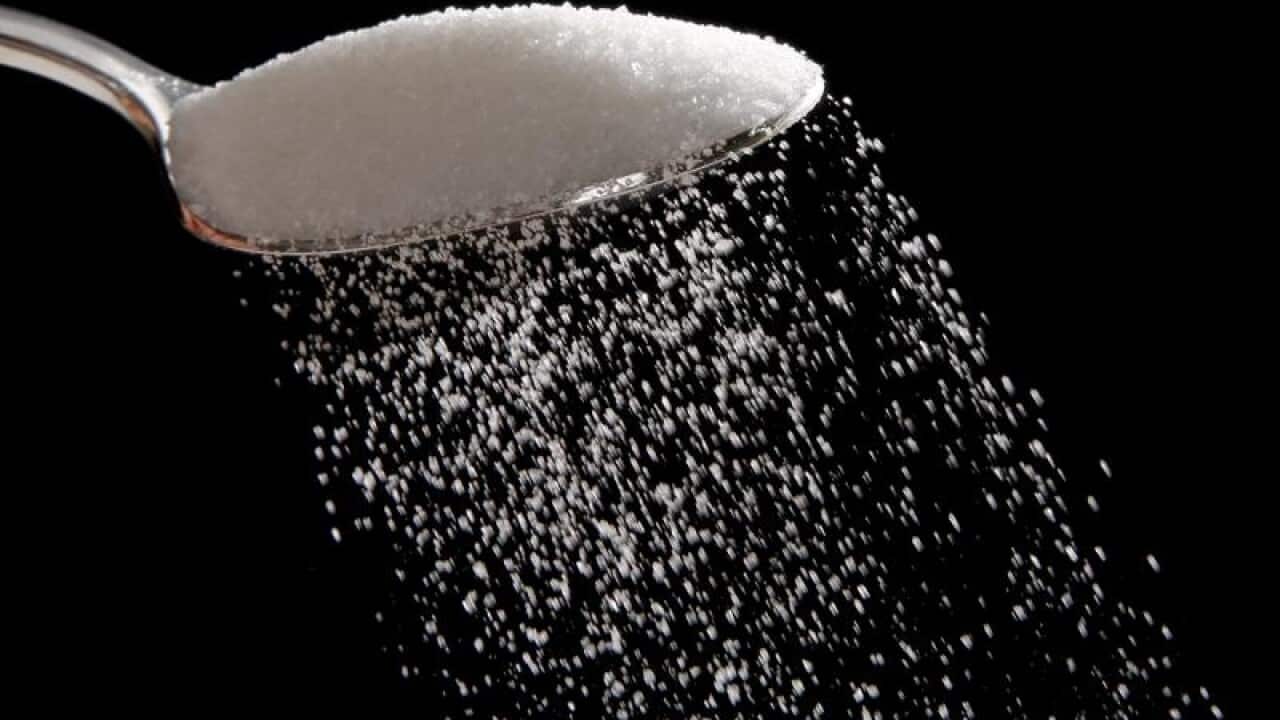 A file photo shows granulated sugar on a spoon.