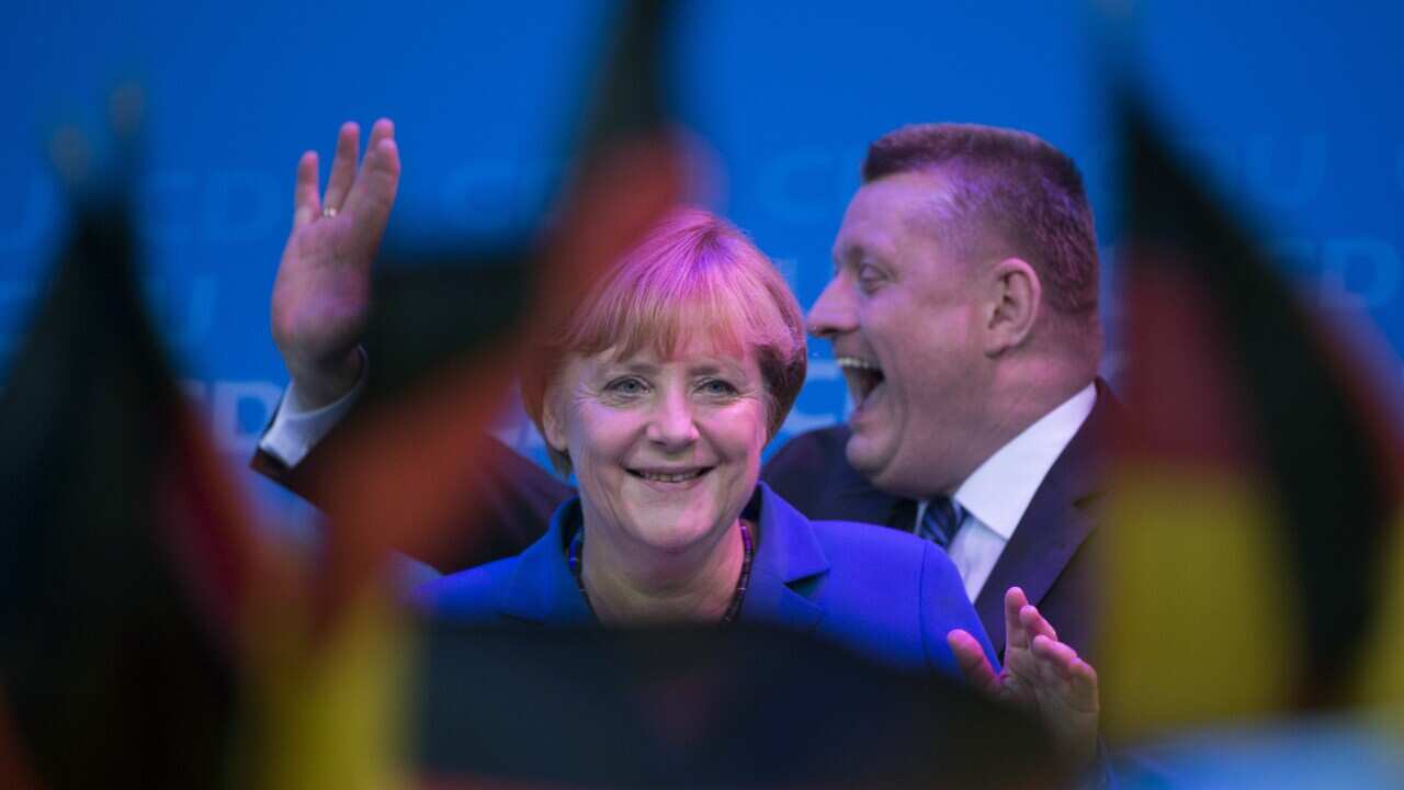 Angela Merkel celebrates with CDU secretary general Hermann Groehe at the Christian Democratic Union party's headquarters in Berlin Getty.jpg