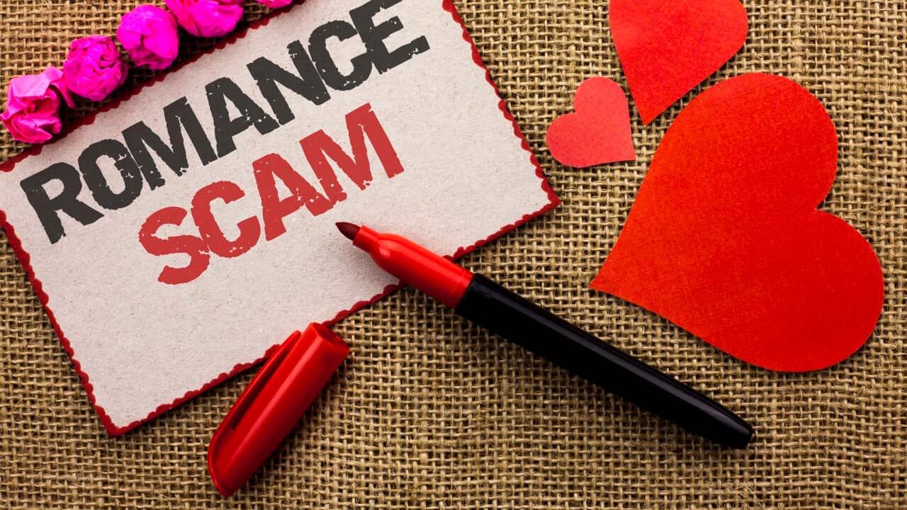 Word writing text Romance Scam. Business concept for Dating Cheat Love Embarrassed Fraud Cyber Couple Affair written on Cardboard Piece on the jute background Marker and Hearts next to it.
