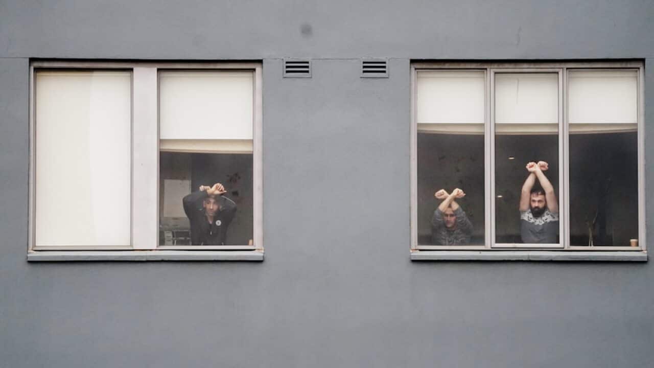 Refugees participate in a "Free The Refugees" rally at the Mantra Hotel in Melbourne.