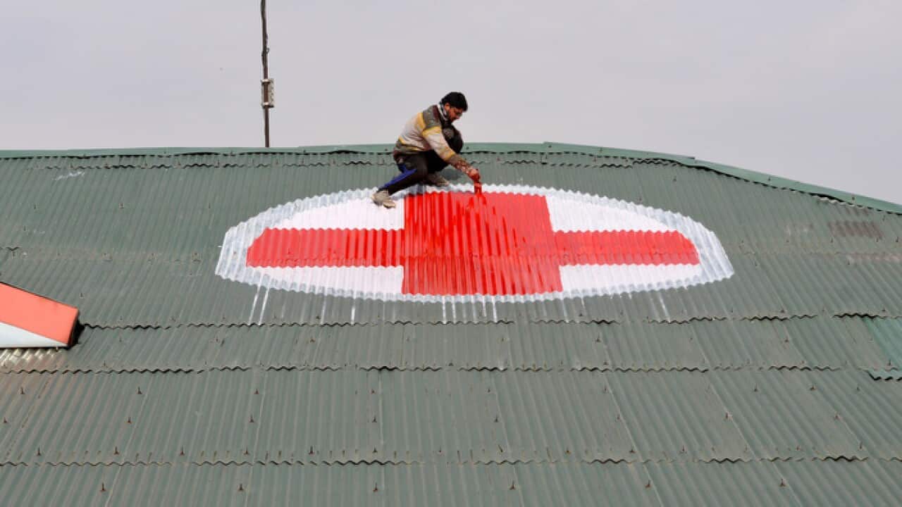 Locals are painting red crosses on hospital roofs in Srinagar as tensions in Kashmir escalate between India and Pakistan