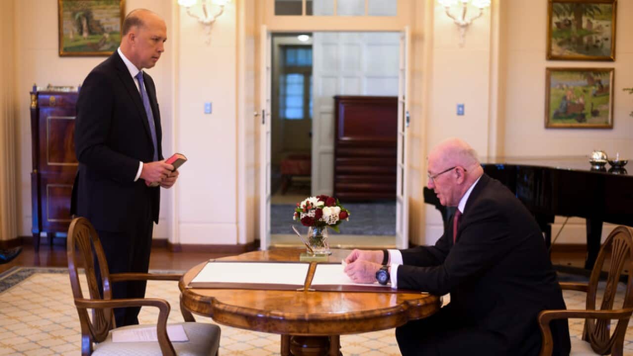 Liberal MP Peter Dutton (left) is sworn in as Home Affairs Minister