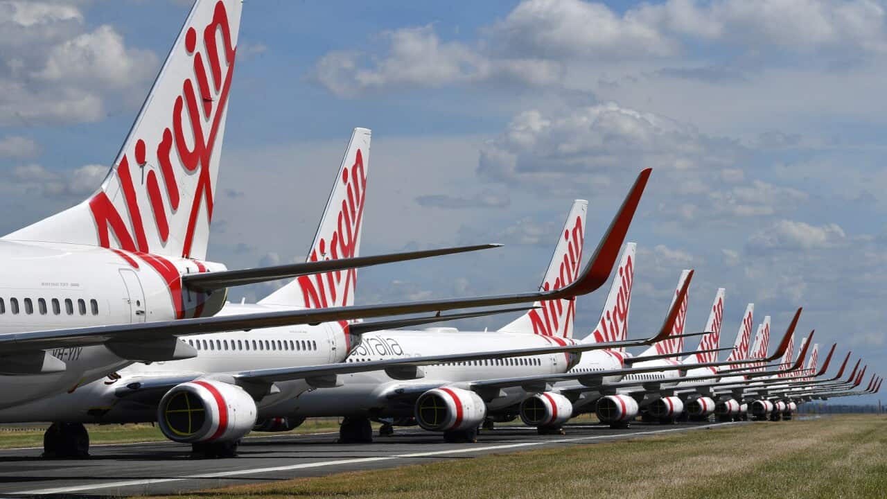Grounded Virgin Australia aircraft are seen parked at Brisbane Airport