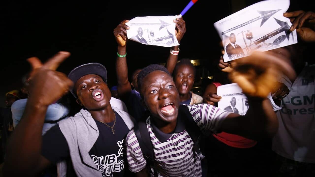Supporters of the Coalition for Democratic Change (CDC) celebrate in the streets after George Weah wins in a runoff presidential election.