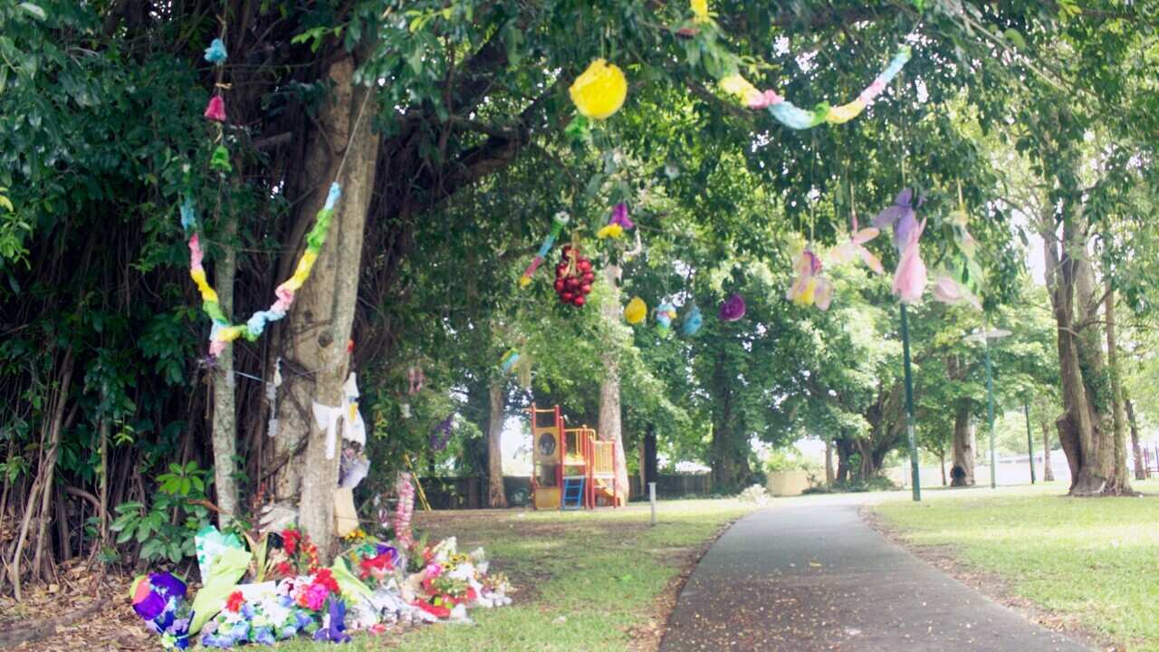 Floral tributes on Thursday lay near the home where the lives of eight children were taken before Christmas last year in Cairns in far north Queensland.