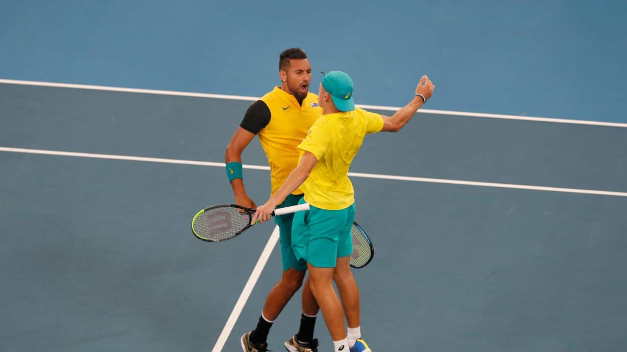 Australia's Alex De Minaur, left, and Nick Kyrgios celebrate after winning a match point against Britain's Jamie Murray and Joe Salisbury during their ATP Cup tennis doubles match in Sydney, Thursday, Jan. 9, 2020. (AP Photo/Steve Christo)