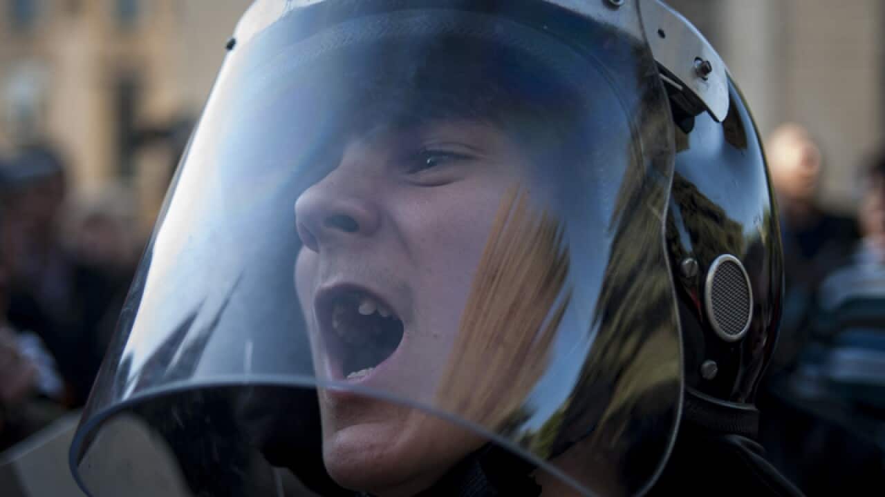 Ukrainian Army soldiers line up in front of Pro Russia civilians