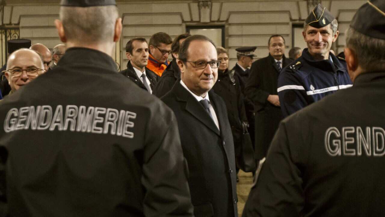 French President Francois Hollande speaks to police officers