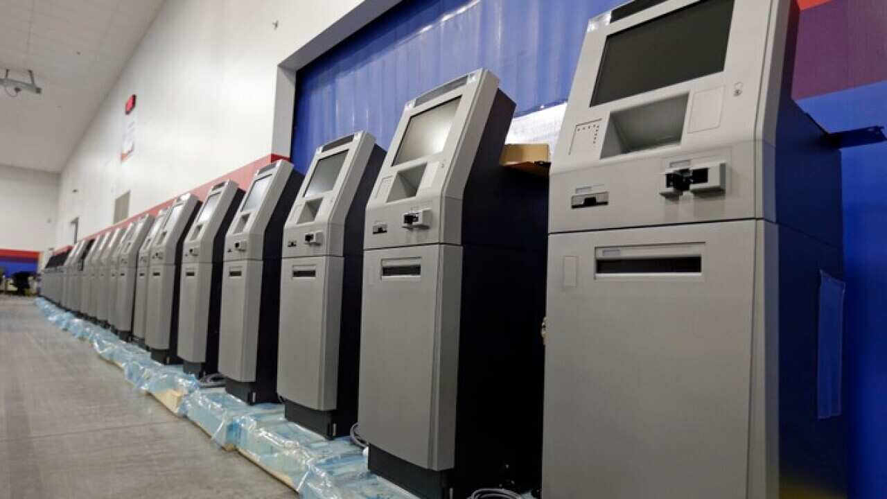 In this Wednesday, Aug. 30, 2017, photo, automated teller machines are lined up during the manufacturing process at Diebold Nixdorf in Greensboro, N.C. (AP Photo/Gerry Broome)