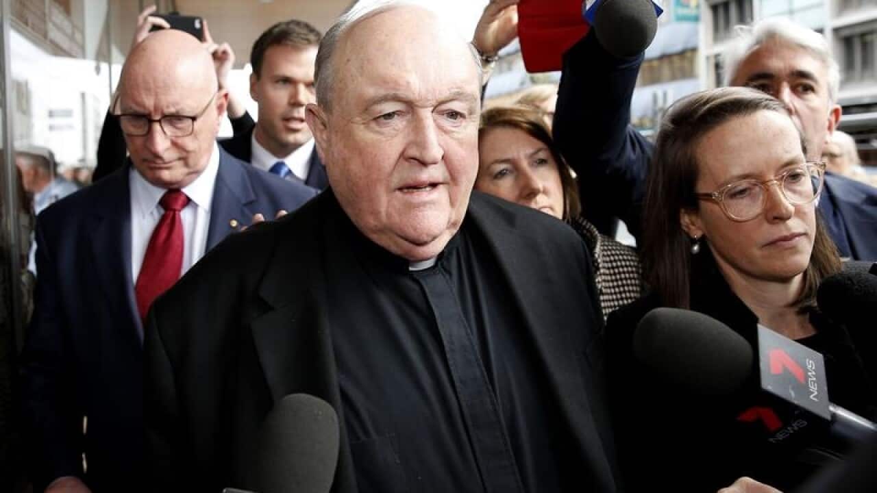 Archbishop Philip Wilson leaves Newcastle Local Court.