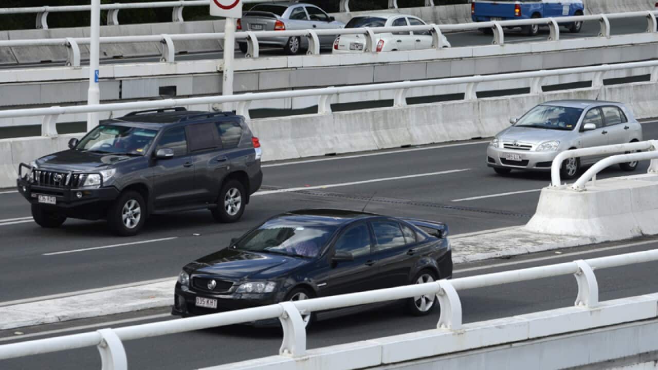 Cars travel along the Pacific Motorway in Brisbane