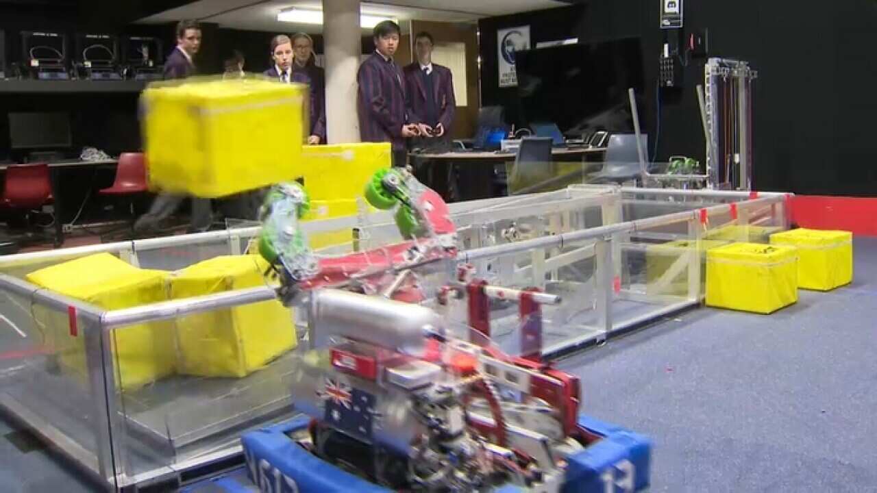 Barker College students with their robot at work