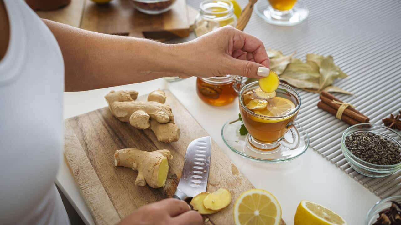Woman preparing ginger and lemon hot tea