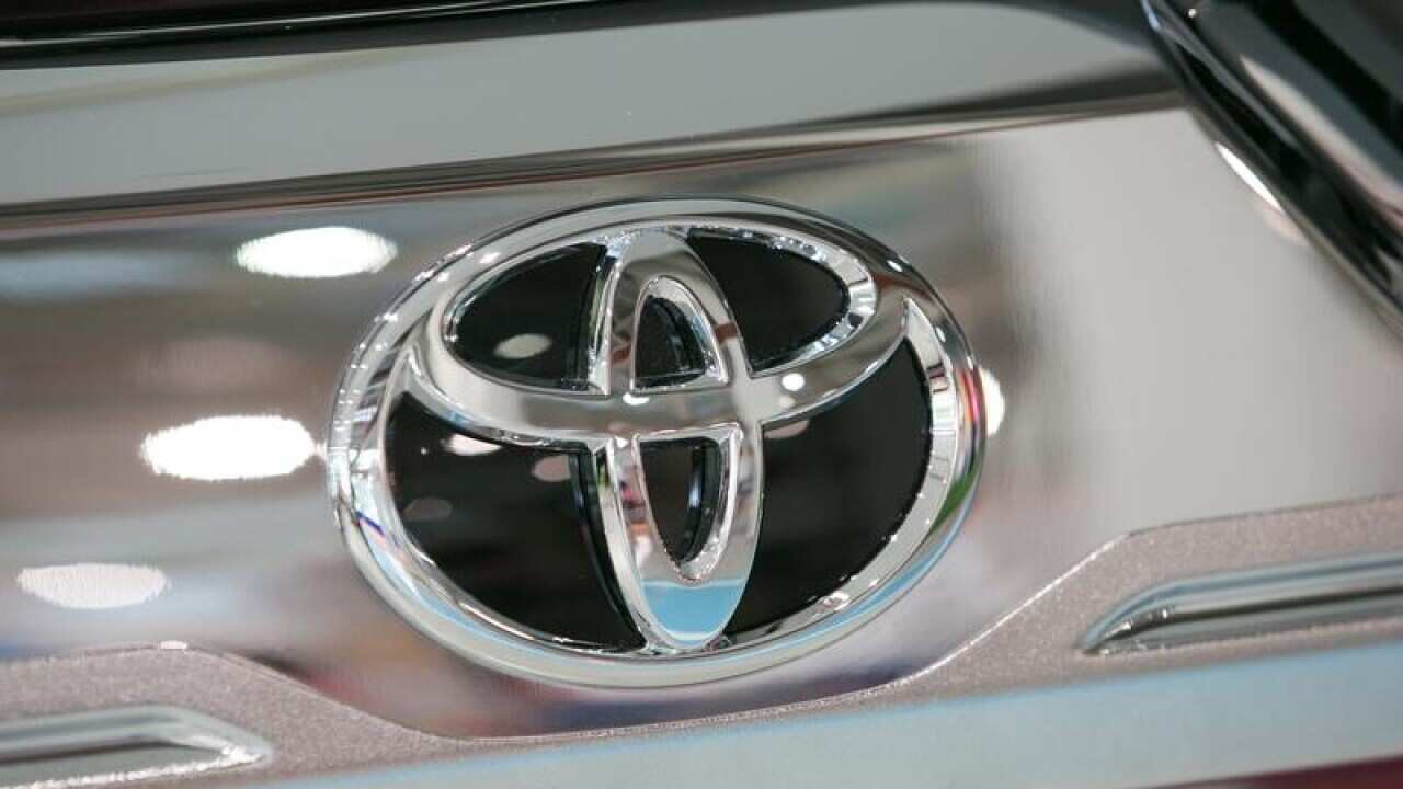 A logo of Toyota is shown on the back of a vehicle