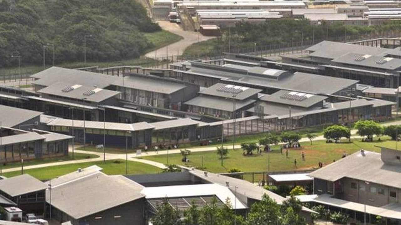 Two Iranian asylum seekers have begun a rooftop protest on Christmas Island.