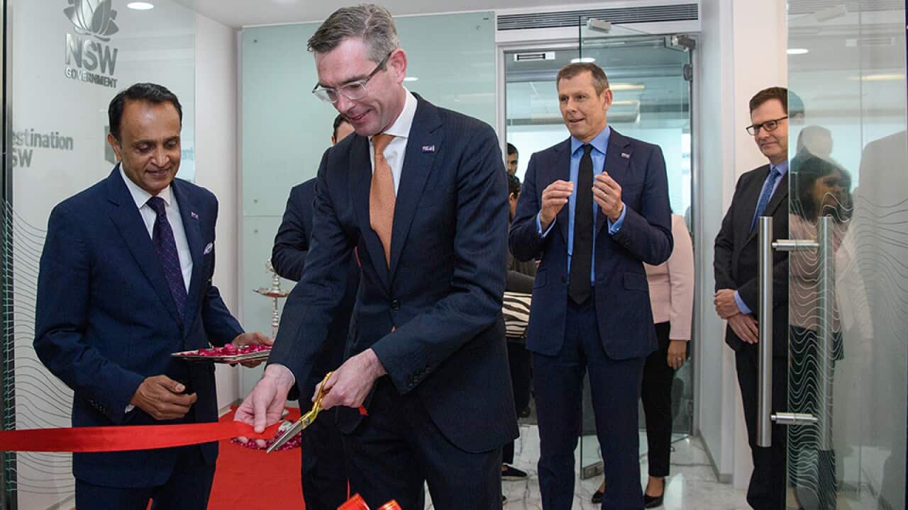 NSW Premier Dominic Perrottet (centre) cuts the ribbon to officially open of NSW’s Trade and Investment Office, during the NSW Premier’s trade mission trip in Mumbai, India, Thursday, July 28, 2022. (AAP Image/Bianca De Marchi) NO ARCHIVING