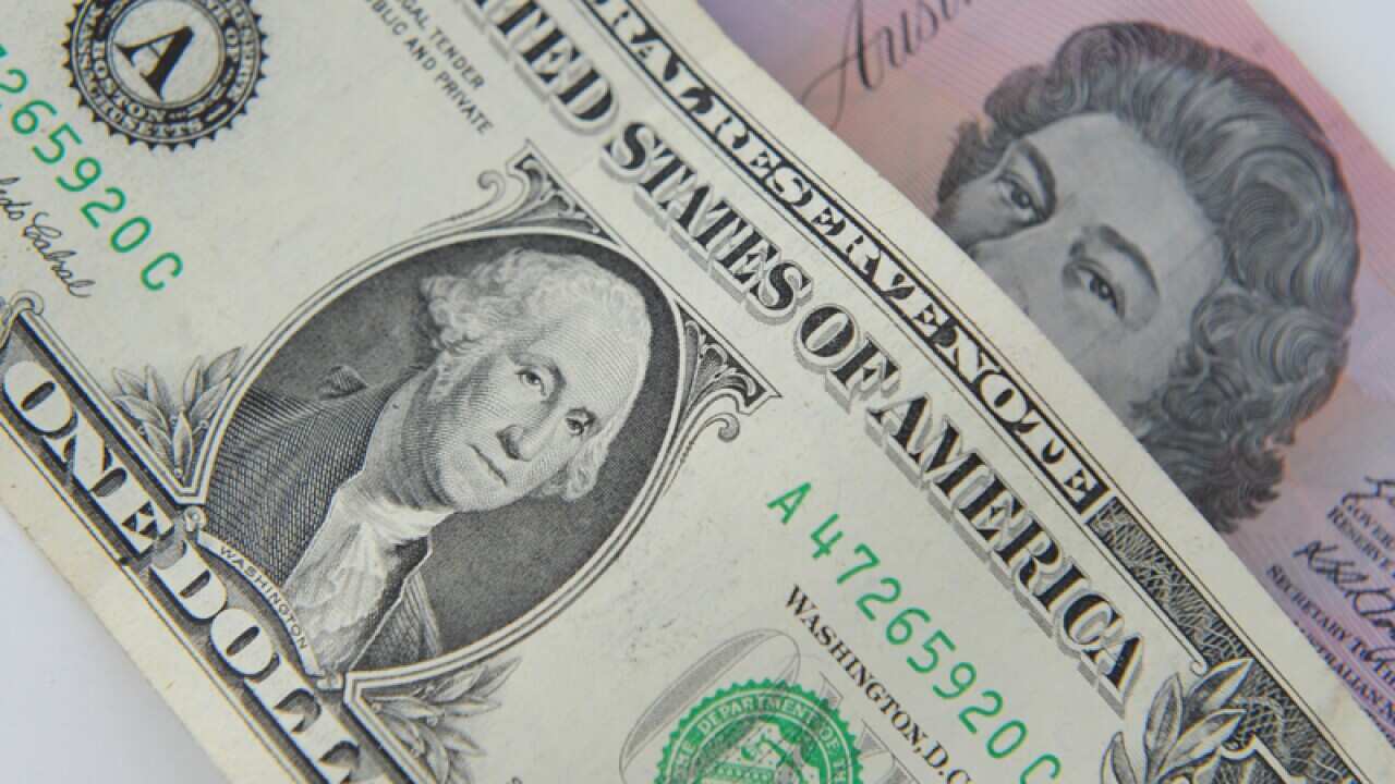 A US dollar note and a $A5 bill