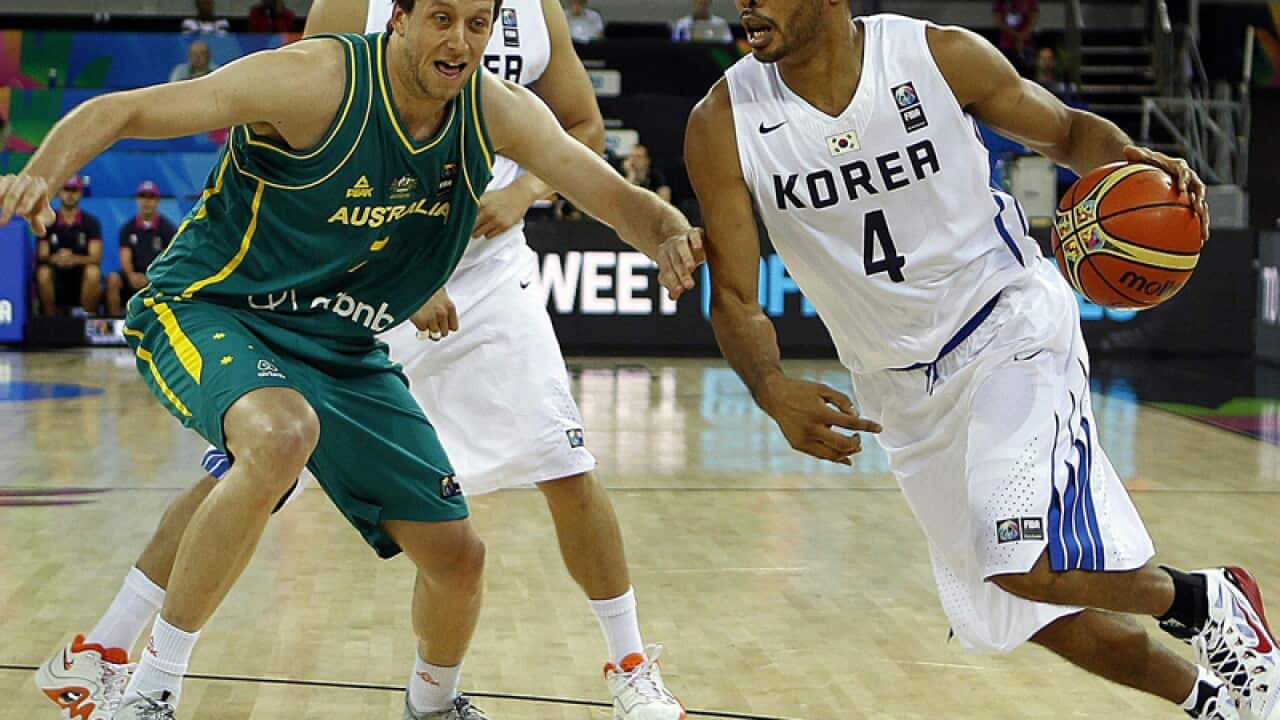 Moon Tae-jong (R) of South Korea in action against Joe Ingles (L)