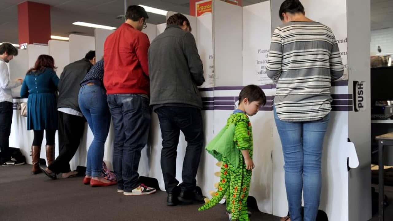 Voters prepare to cast their vote