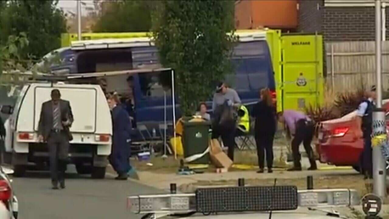 The smoke blanketing the area where a house fire broke in Canberra, killing three people.