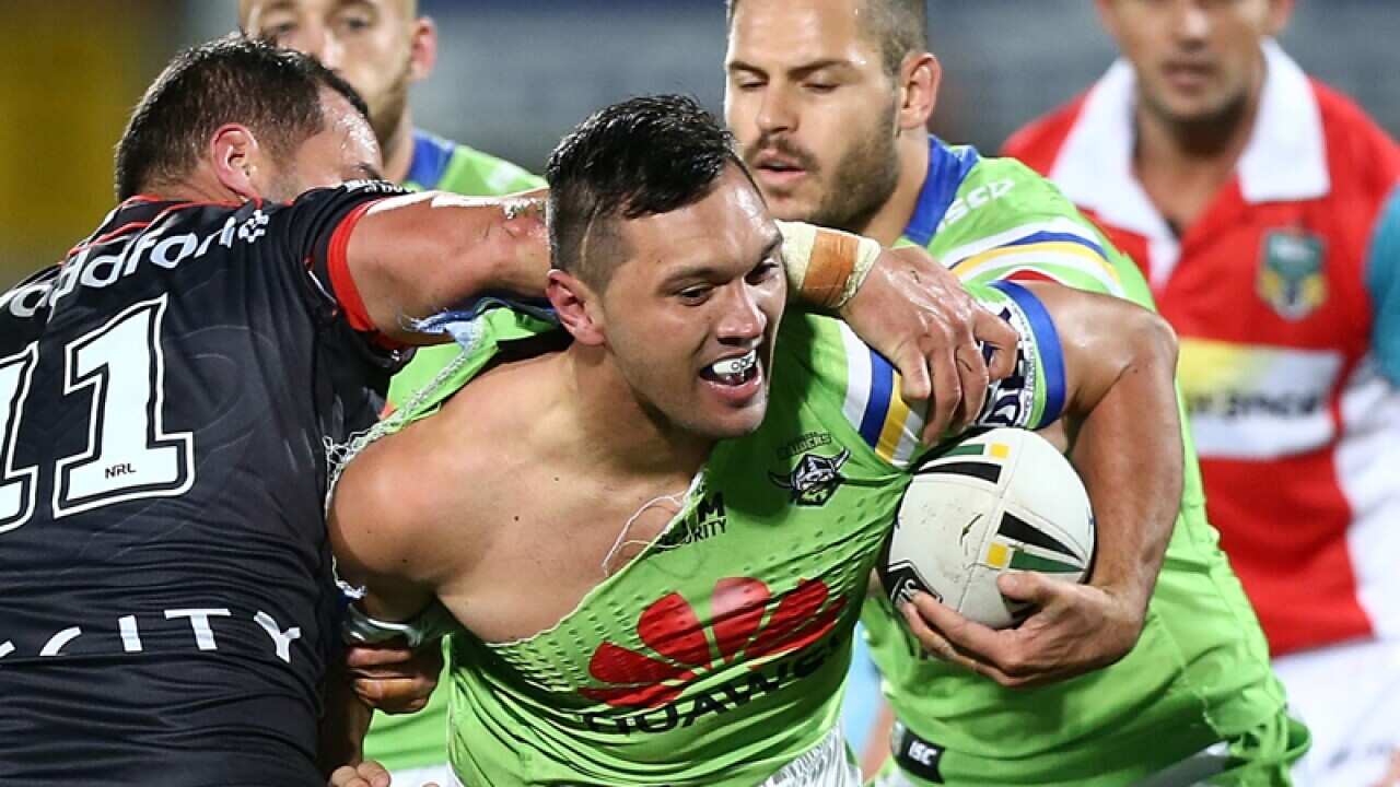 Jordan Rapana of the Raiders is tackled by Bodene Thompson