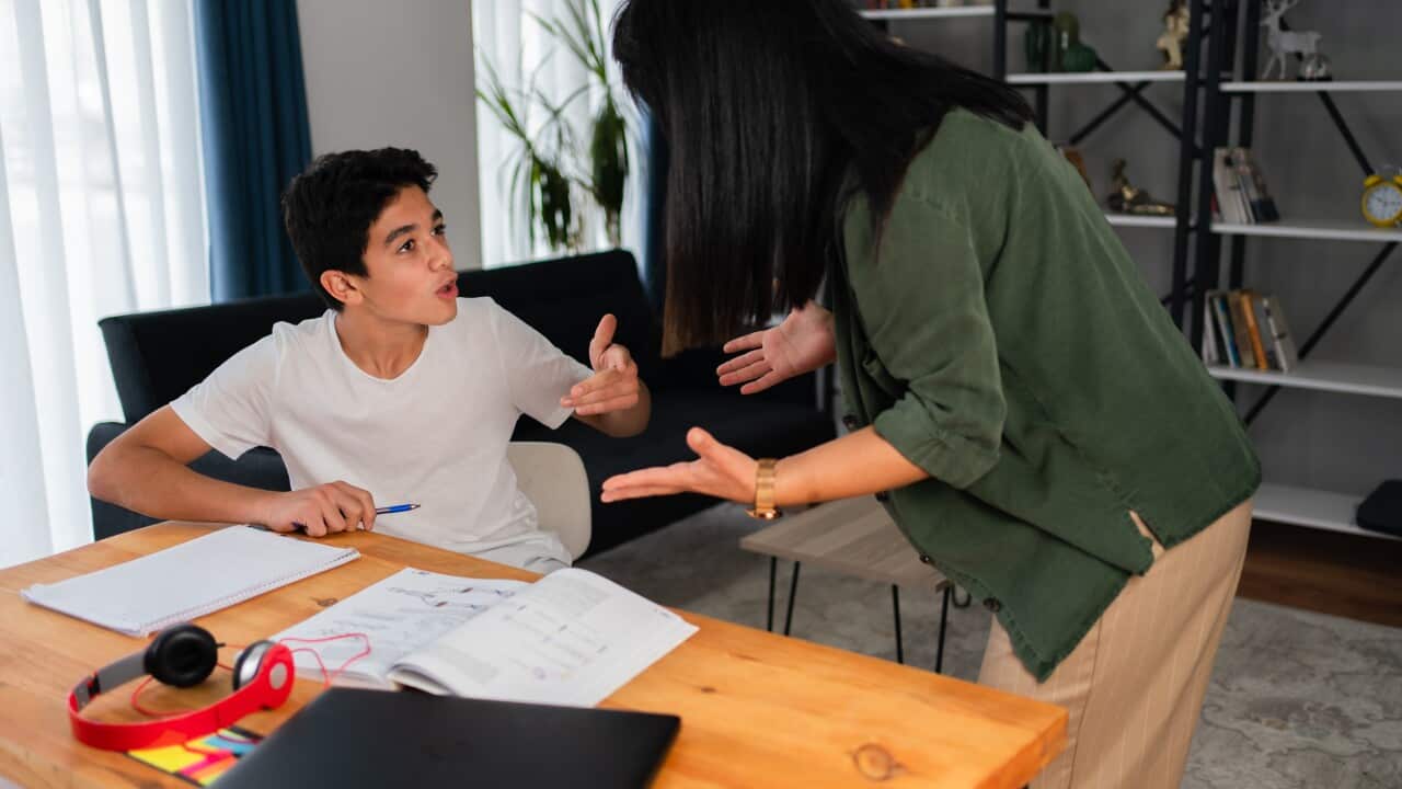 Mother and her teenage son arguing at home