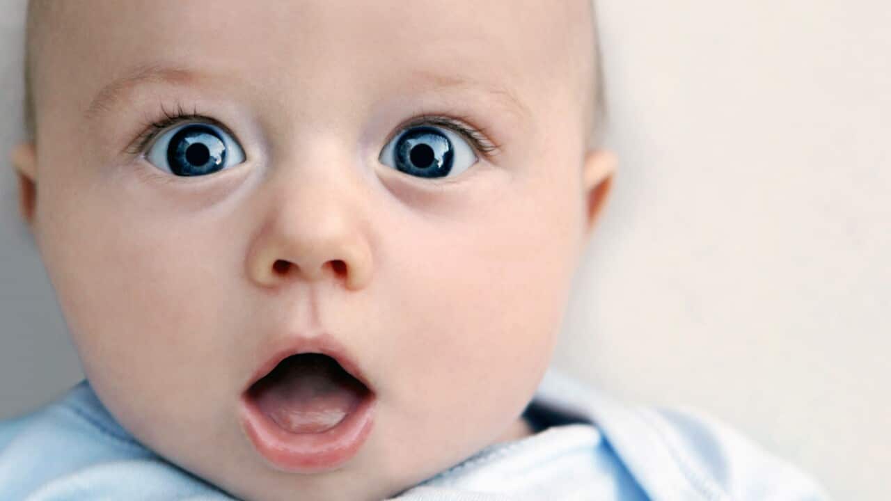 Surprised baby boy looking at camera
