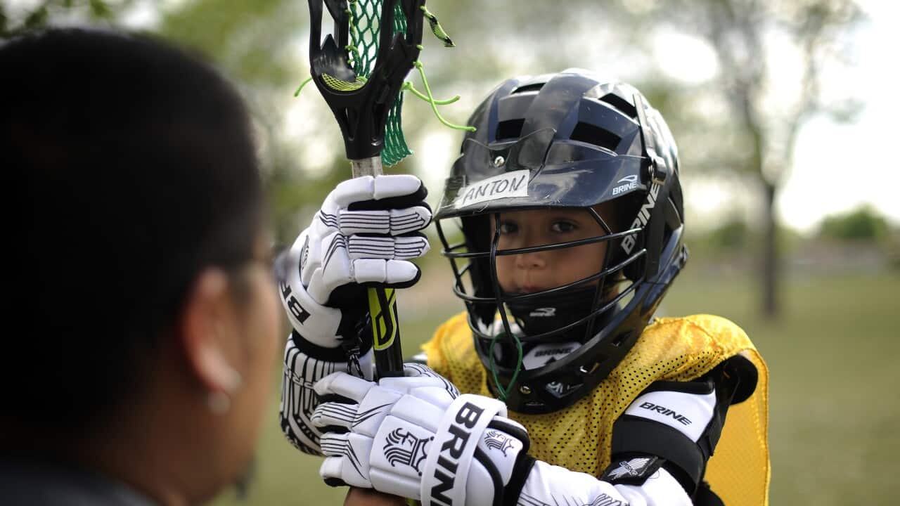 Six year old Anton McCray is learning fundamental Native American Lacrosse techniques