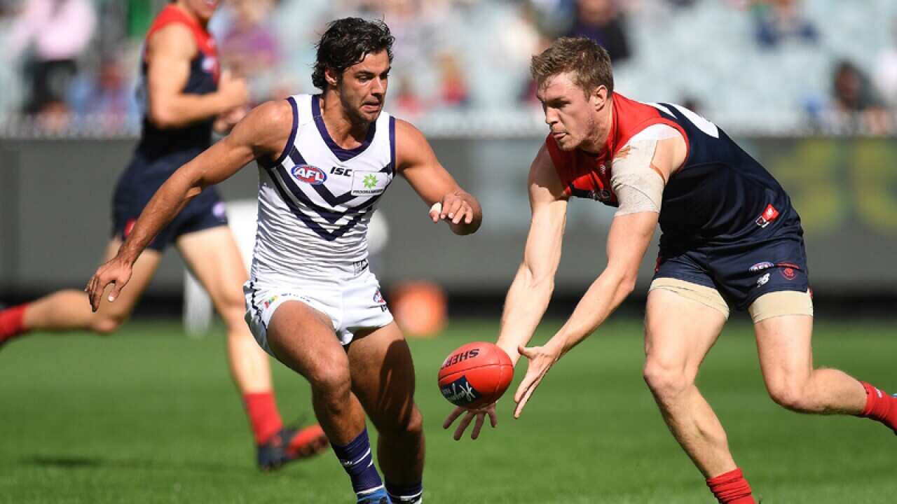 Brady Grey of the Dockers (left) and Tom McDonald of the Demons