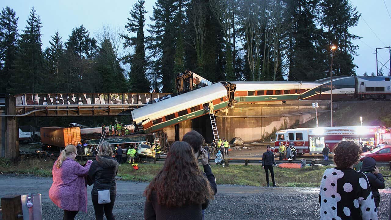 First responders work at the scene of an Amtrak train that derailed in DuPont, south of Seattle on Monday, December 18, 2017. 