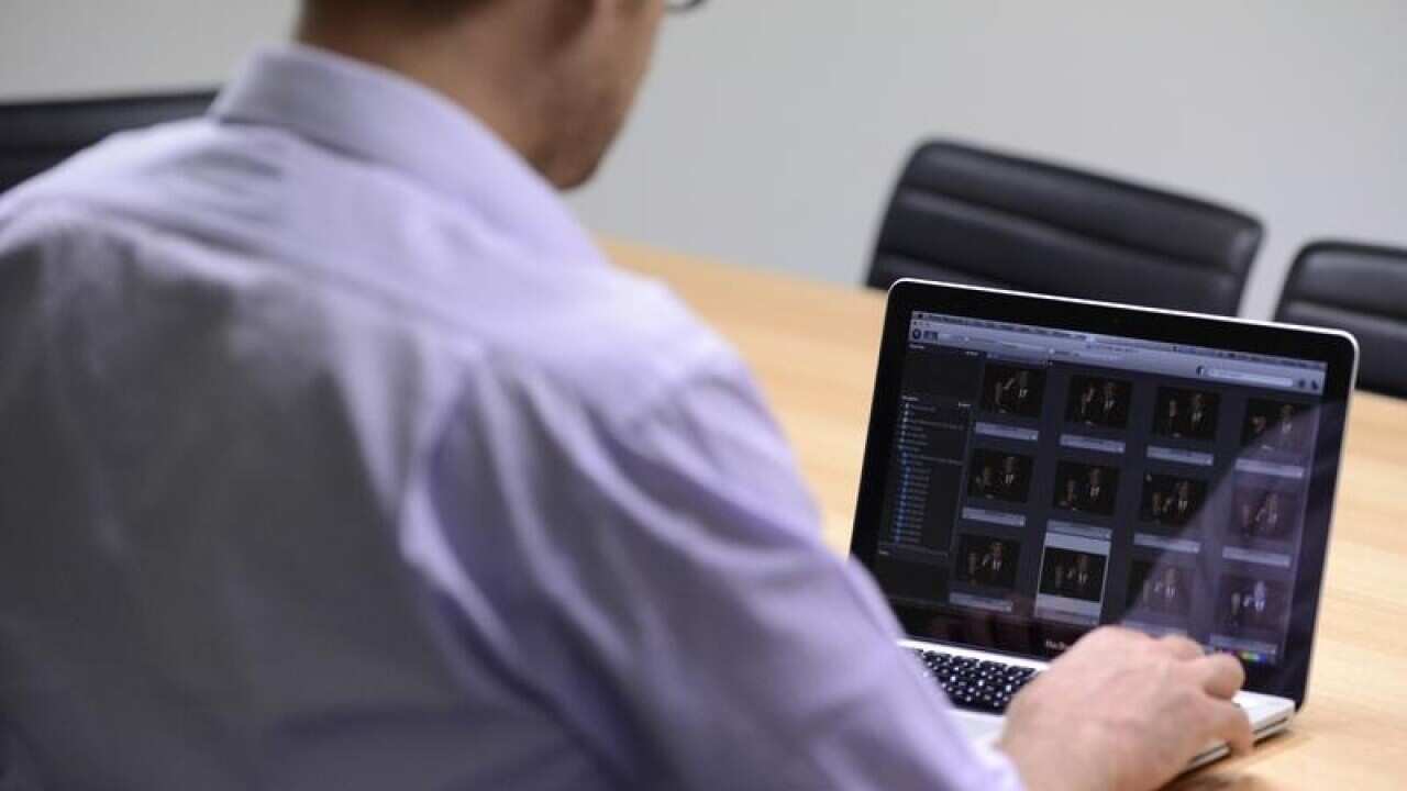A man uses a laptop computer