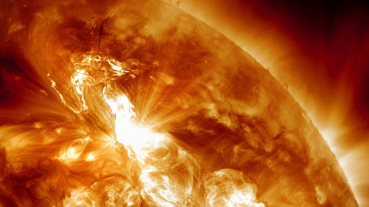 shows a  solar flare erupting on the Sun