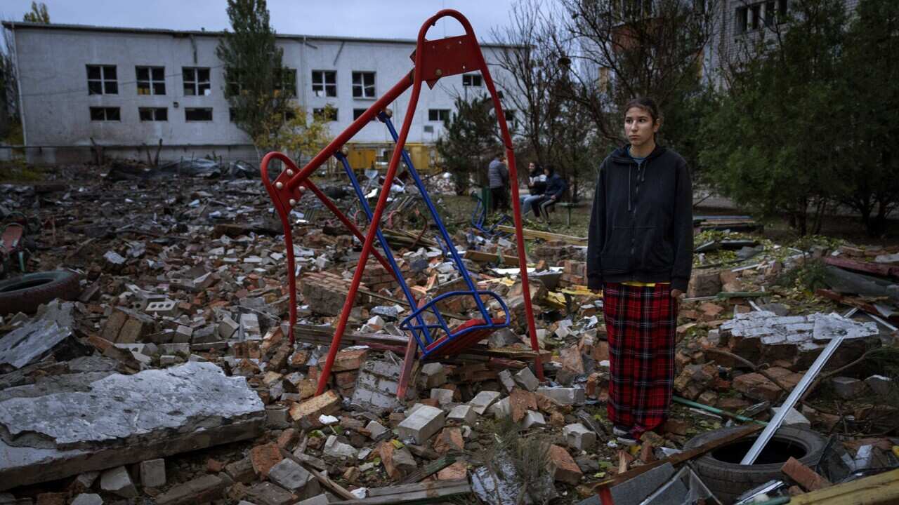 A teenager stands in the rubble at Mykolaiv (AAP).jpg