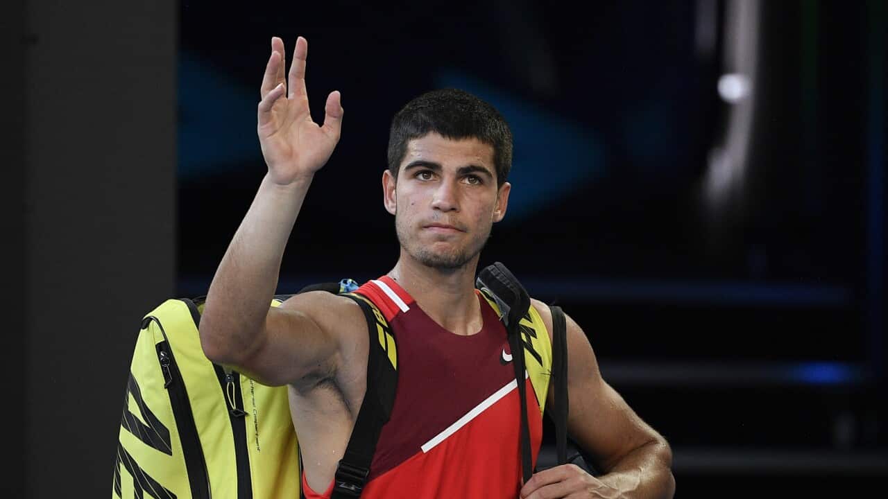 Carlos Alcaraz of Spain waves as he leaves Rod Laver Arena following his third round loss to Matteo Berrettini at the Australian Open 2022