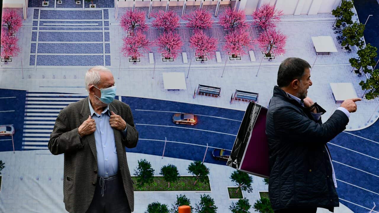 People stand at Syntagma square, Athens, Greece, Tuesday, Nov. 9, 2021.