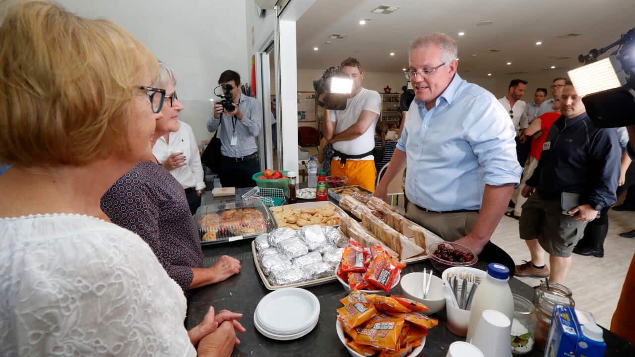 Prime Minister Scott Morrison speaks with volunteers while visiting the relief centre in Lobethal, South Australia, Tuesday, December 24, 2019. The Prime Minister is touring fire affected areas in South Australia. (AAP Image/Kelly Barnes) NO ARCHIVING